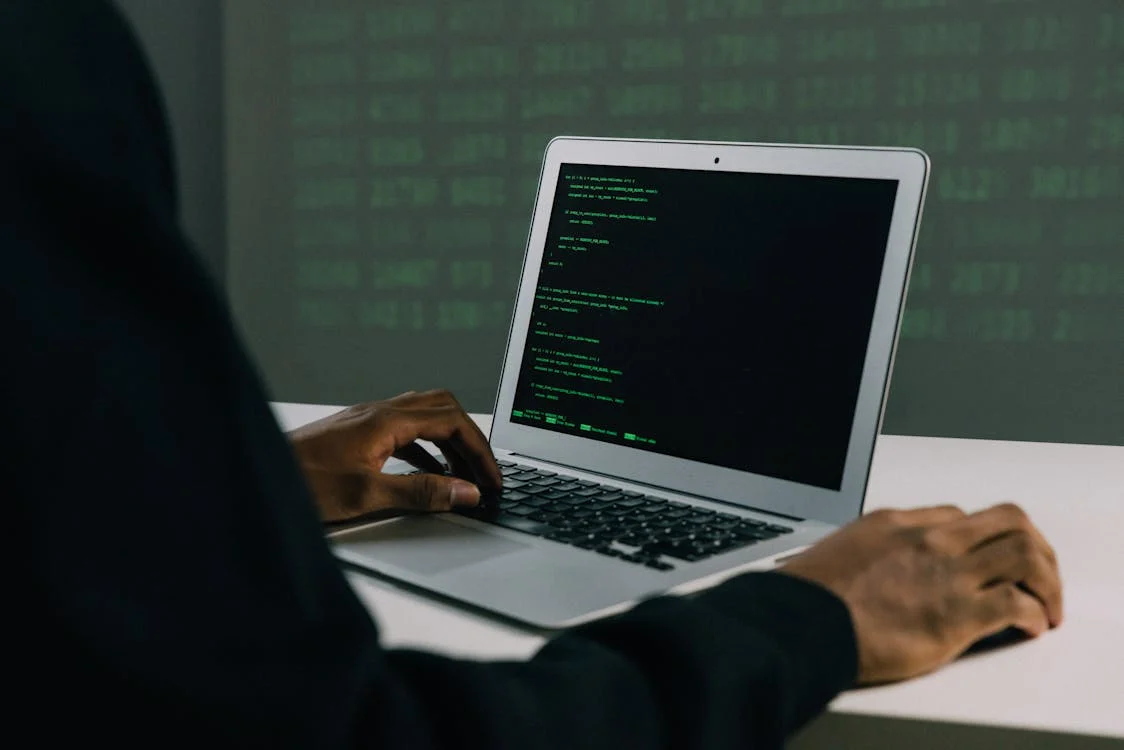 Cybersecurity coder working on a laptop